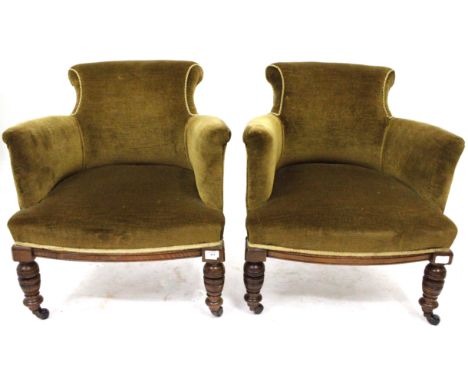 A PAIR OF VICTORIAN GREEN UPHOLSTERED TUB CHAIRS with scrolling backs, bow fronted fronts and ring turned walnut tapering leg