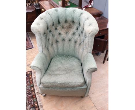 A VICTORIAN BUTTON BACK UPHOLSTERED ARMCHAIR