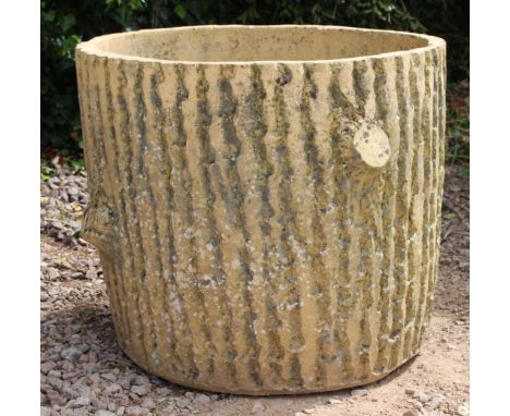 A LARGE BUFF TERRACOTTA RUSTICATED PLANTER in the form of a tree trunk section, approximately 65cm diameter x 55cm high