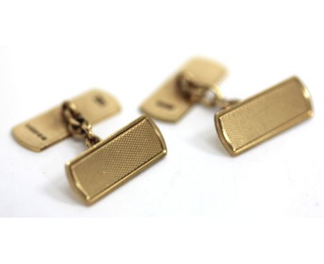 A PAIR OF OVAL 9 CARAT GOLD CUFFLINKS, c.1921 and a pair of 9 carat gold oval cufflinks with engraved decoration together wit