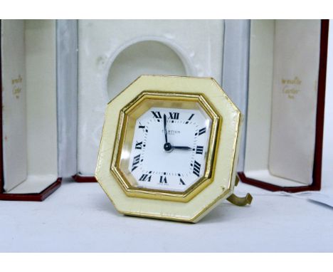 A CARTIER OF PARIS DESK OR BEDSIDE ALARM CLOCK with octagonal case, conforming dial with Roman numerals, signed 'Cartier', nu