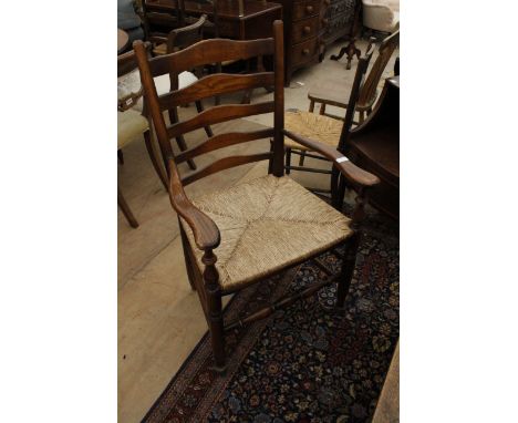 A SET OF FIVE LATE 20TH CENTURY LADDER BACK KITCHEN CHAIRS with rush seats (two carvers)