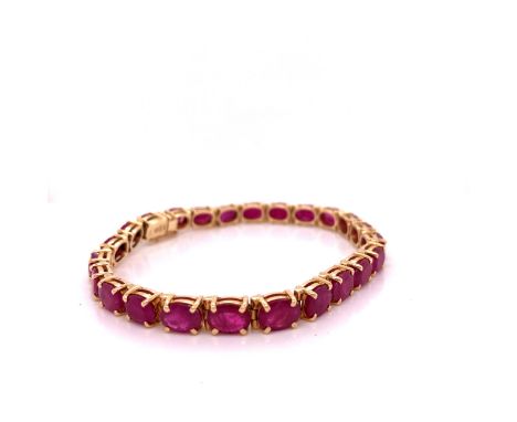 A 14ct OVAL CUT CLAW SET RUBY BRACELET. LENGTH 18cms, GROSS WEIGHT 17.5grms. 