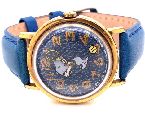 A VINTAGE MANUAL WOUND SNOOPY WRIST WATCH FEATURING SNOOPY PLAYING TENNIS WITH A TENNIS BALL SECONDHAND AND TENNIS RACKET MIN