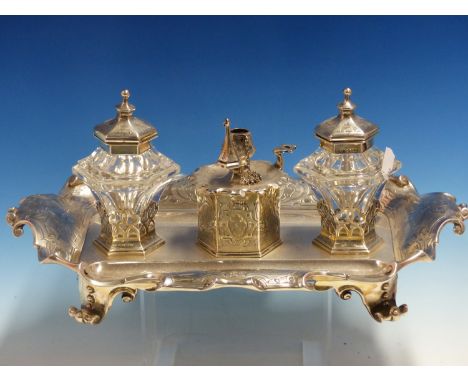 A GOOD VICTORIAN HALLMARKED SILVER DESK STAND WITH TWIN SILVER LIDDED GLASS WELLS CENTERED BY A TAPER STICK WITH SNUFFER. DAT