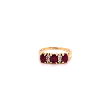 A 14ct YELLOW GOLD DIAMOND AND RUBY HALF HOOP RING. THREE OVAL CUT RUBIES ARE INTERSPERSED WITH A PAIR OF DIAMONDS ALL CLAW S