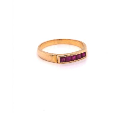 A YELLOW GOLD (UNMARKED) CHANNEL SET RUBY HALF HOOP RING. FINGER SIZE O. WEIGHT 2.7grms.