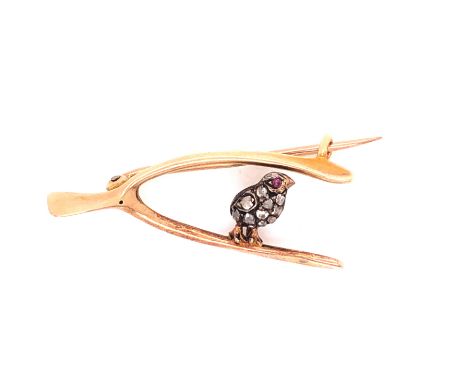 A LATE VICTORIAN GOLD AND DIAMOND BROOCH DEPICTING A DIAMOND CHICK SET WITH OLD CUTS, AND A RUBY CABOCHON SET EYE ON A WISHBO