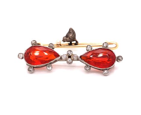 A FIRE OPAL AND DIAMOND BROOCH, THE TWO MATCHING FIRE OPALS ARE PEAR CUT IN A RUBOVER SETTING VARIOUSLY SURROUNDED BY OLD CUT