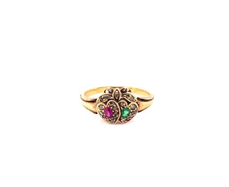 AN ANTIQUE EMERALD, RUBY AND DIAMOND SWEETHEART RING. THE DOUBLE GEM SET HEARTS UNDER A DIAMOND SET BOW. FINGER SIZE I. WEIGH