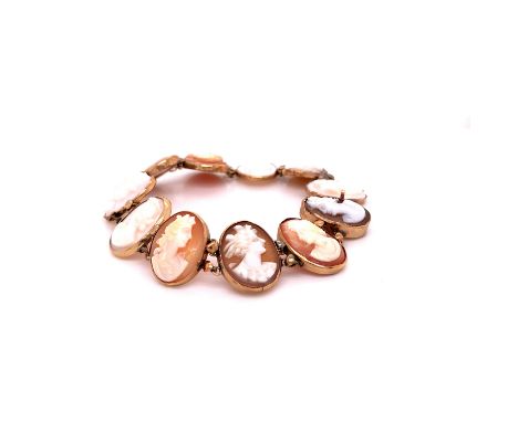 A GOLD AND SHELL PORTRAIT CAMEO BRACELET, CONSISTING OF ELEVEN VARIOUS MAIDENS IN A RUBOVER SETTING. WEIGHT 12.5grms, LENGTH 