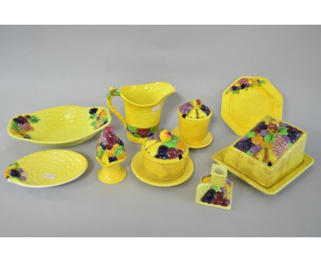Carltonware pottery, the yellow ground moulded with fruit in coloured glazes, 
