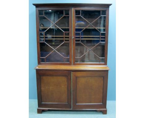 Mahogany bookcase cabinet, top with astragal glazed doors above base with two cupboard doors, to bracket feet 