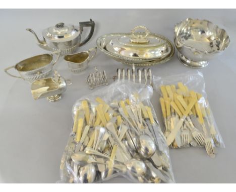 Large collection of silver plate to include a pair of tureens, a three piece tea service, toast racks, and a quantity of cutl