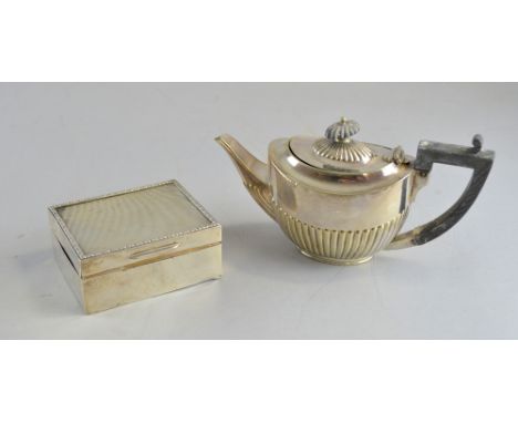 George V silver cigarette box with engine turned decoration, floral border and a silver plated teapot, 