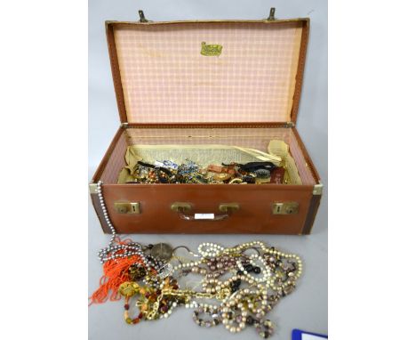 A collection of costume jewellery in a case, including some silver items, necklaces brooches and a swatch pop watch 