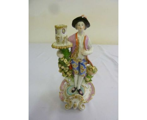 Dresden porcelain candlestick in the form of a man in traditional dress