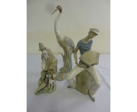Lladro three figurines - Man and dog, Sailor playing musical instrument and a Stork - all A/F