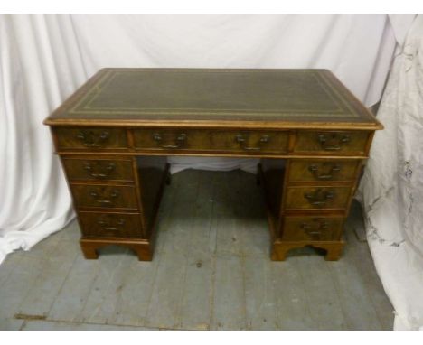 Late Victorian rectangular desk with tooled leather top and nine drawers on bracket feet