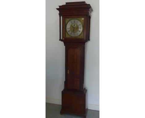 An 8 day longcase clock with a square brass dial with a seconds hand and signed Chas Gretton, London - contained in an oak ca