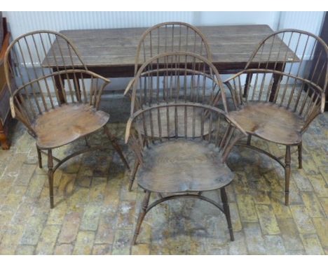 A pine top kitchen table - Height 69cm x 183cm x 74cm with a set of stick back Windsor armchairs with crinoline stretchers - 