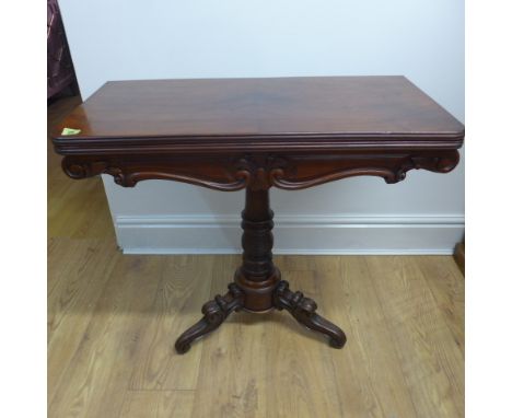 A mahogany fold over card table on a scroll tripod base - Height 72cm x Width 79cm 