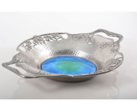 Liberty & Co., a Tudric pewter and enamel floral dish, circa 1900, the pierced floral rim surrounding a green and blue enamel