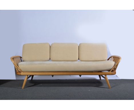 Lucian Ercolani for Ercol, an elm and beech Studio Couch, shape 355, single seat cushion and three back cushions in cream uph