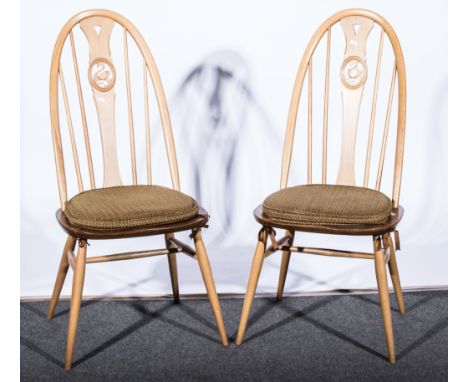 Lucian Ercolani for Ercol, a set of four elm 'Swan' chairs, shape 876, applied gold labels, rounded oyster shape seat covers 
