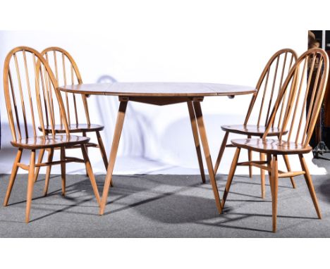 Lucian Ercolani for Ercol, an elm and beech dining suite, comprising sideboard (shape 351), a rounded shaped dining table (sh