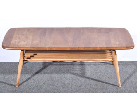 Lucian Ercolani for Ercol, an elm and beech occasional coffee table, (shape 398), with magazine rack undertier, length 104cm,