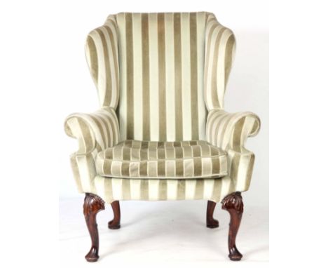 A GOOD QUEEN ANNE STYLE WALNUT UPHOLSTERED WINGBACK ARMCHAIR with shaped angled scrolled arms with loose cushion seat; standi