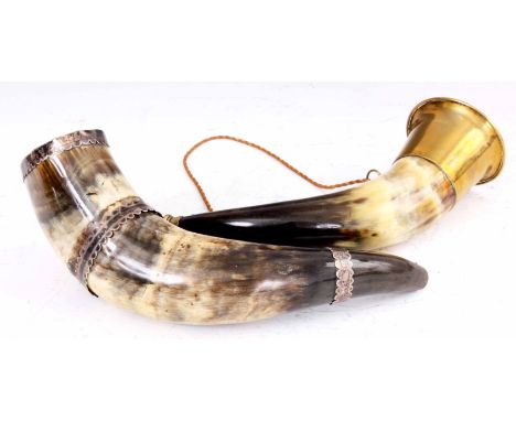 TWO 19TH CENTURY COW HORN HUNTING HORNS with silver and brass mounts, each 28cm across.