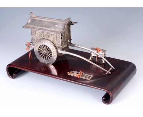 A MEIJI PERIOD JAPANESE SILVER JEWELLERY CASKET IN THE FORM OF A CARRIAGE with a silver ladder and bench mounted on a hardwoo
