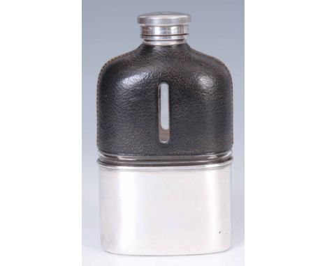 A GEORGE V LARGE HALF LEATHER BOUND GLASS HIP FLASK of shouldered form with screw on silver top and pull off silver cup base 