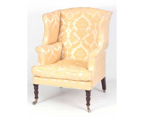 A STYLISH LATE GEORGE III MAHOGANY WING BACK ARMCHAIR the gold damask upholstered frame with loose cushion seat on ringed tur