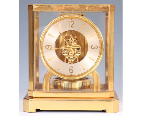 A JAEGER-LECOULTRE ATMOS CLOCK the gilt brass framed case inset with five glass panels enclosing a skeletonised chapter ring 