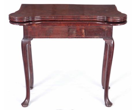 AN UNUSUAL GEORGE I INLAID FIGURED WALNUT GAMES TABLE with outset corners and hinged top revealing a card playing surface and