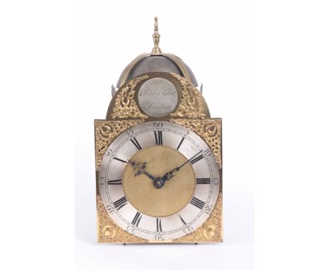 RALPH GOUT, LONDON. A GEORGE III LANTERN CLOCK having brass bell straps supporting a large bell above an 8" brass arched dial