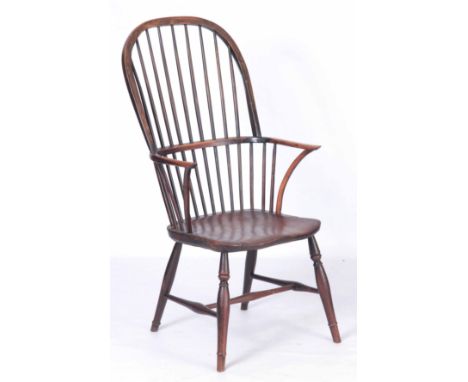 AN EARLY 19TH CENTURY AND LATER YEW-WOOD STICK BACK WINDSOR CHAIR with crook arms, Elm saddle seat and ring turned legs 108cm