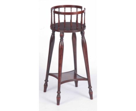 A LATE GEORGIAN PERIOD MAHOGANY PLATE STAND IN THE MANNER OF GILLOWS with finely turned gallery circular top; standing on fou