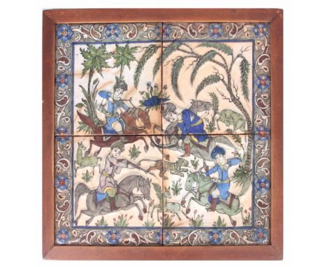 A 19TH CENTURY PERSIAN QUJAR FOUR TILE PANEL depicting a Tiger hunt, moulded tiles with an Isnik style border in a later pine