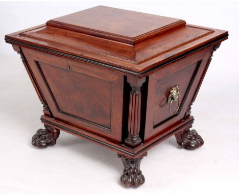 A STYLISH REGENCY MAHOGANY SARCOPHAGUS WINE COOLER of tapering panelled form with free standing turned and reeded corner colu