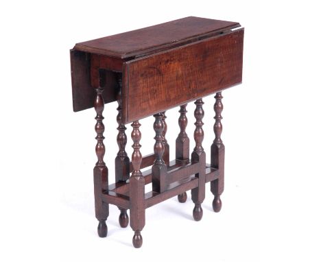 A RARE LATE 17TH CENTURY WALNUT DROP LEAF GATE LEG TABLE OF SMALL SIZE with end drawer; standing on ring turned supports join