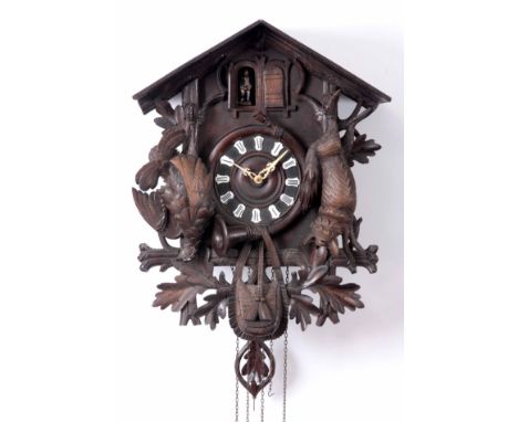 A LATE 19th CENTURY BLACK FOREST MUSICAL CUCKOO CLOCK the architectural carved case with hung fox and pheasant above game bag