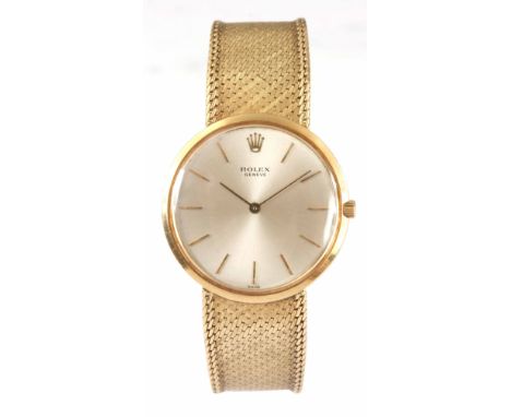 A GENTLEMAN'S 18CT GOLD ROLEX WRIST WATCH the slim circular case enclosing a silvered dial with baton markings fronting a jew