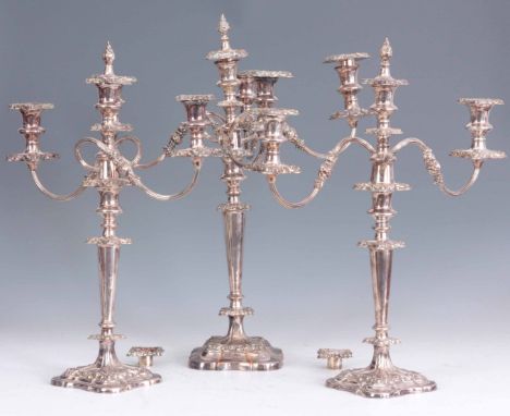 A SET OF THREE LATE 19th CENTURY SILVER PLATED CANDELABRA with removable reeded scrolled arms on tapered stems and shaped bas