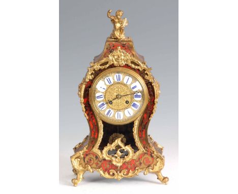 A LATE 19th CENTURY FRENCH BOULLE MOUNTED TORTOISESHELL MANTEL CLOCK the balloon shaped case surmounted by a seated cherub on