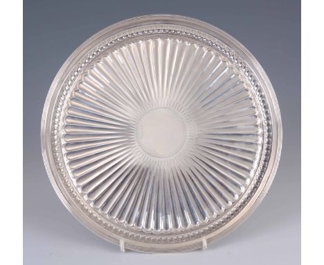 A LATE 19th CENTURY SILVER SALVER having ribbed border and fluted centre raised on three claw feet 25.5cm diameter - Edward H