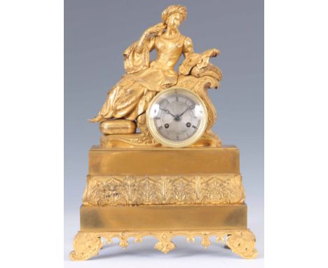 A MID 19th CENTURY FRENCH ORMOLU FIGURAL MANTEL CLOCK modelled as a lady in Eastern dress seated on cushioned ottoman enclosi